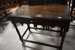 A Victorian oak side table having carved lunette decoration