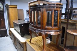 A modern hardwood drinks cabinet having lift off tray top and glazed storage section (double