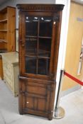 A pair of Titchmarsh & Goodwin reproduction corner display cabinets, design RL23044 (right and