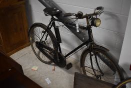 An early 20th Century push bike , possibly Raleigh having Brooks seat and Dynolux dynamo with