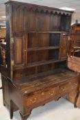 A period oak dresser having delft rack over two drawer base, on cabriole legs, width approx. 136cm
