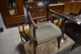 A 19th Century Regency design carved chair having later upholstery
