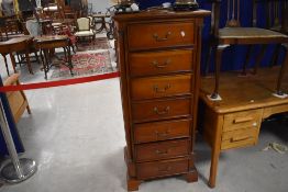 A modern hardwood narrow bedroom chest of seven drawers, height approx. 136cm