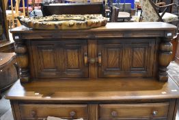 A mid stain Ercol court cupboard, width 123cm