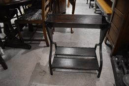 An early 20th Century oak book trough on stand, width approx. 57cm