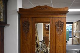 A late 19th or early 20th Century oak single mirror door wardrobe , having Art Nouveau style