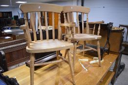 A pair of vintage beech kitchen armchairs having turned frames and H stretcher