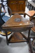 An early 20th Century oak occasional table having triangular/circular top on twist legs and