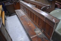 A traditional pitch pine church pew, cut into two lengths, approx. 236 and 234cm, with some