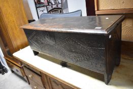 A period oak kist of naive form with carved decoration, dimensions approx. W105 D38 H42cm