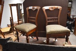A pair of Victorian dining chairs having bobbin turned rail back and overstuffed drop on seats