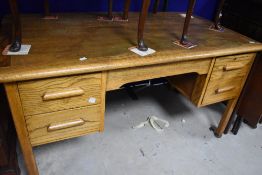 A mid 20th Century oak office desk, width approx. 137cm