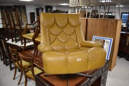 A vintage mustard/ochre vinyl armchair on chrome swivel frame