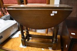 A vintage oak drop leaf occasional table, width approx. 61cm