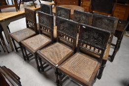 A set of eight 19th Century cane seated bedroom chairs having interesting embossed leather backs ,
