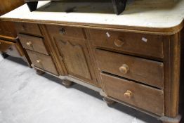 A Victorian scumbled pine sideboard having part painted top and ledge back, approx. W178