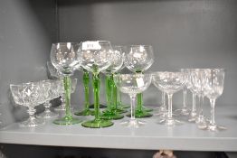 A set of nine green stemmed wine glasses sold along with a selection of champagne and spirit