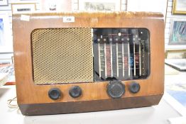 A vintage 1950's PYE walnut veneered radio, of typical form with glass tuner scale and metal speaker