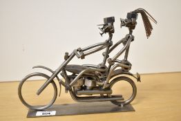 A decorative metal figure group constructed from welded nuts, bolts and other fittings, depicting