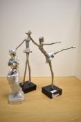 A pair of metal ballerina figurines mounted on black square bases, measuring 37cm tall