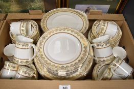 A 20th Century bone china part dinner service having gilt heightened design, stamped to base