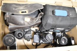 A group of three Minolta cameras and carry cases, XG-M with MD 35-70/35 lens, a Dynax 7XI with