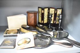 A mahogany vanity set to include two hand mirrors and two brushes, a pair of mahogany