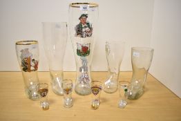 A collection of nine late 20th-century/modern German boot-shaped beer glasses, six featuring novelty