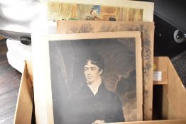 An assortment of unframed pictures and prints.