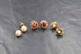 Three pairs of 9ct gold earrings of various designs, two pairs having pearl decoration one having