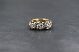 An 18ct gold diamond trilogy ring having three brilliant cut diamonds totalling approx 1ct in an