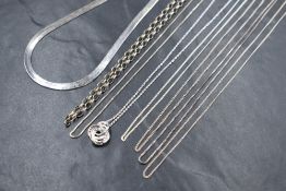 A group of eight silver chains, including fine curb link, box chains, belcher link chain and a snake