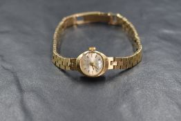 A lady's 9ct gold wrist watch by Regency having baton numeral dial to small face in 9ct gold case