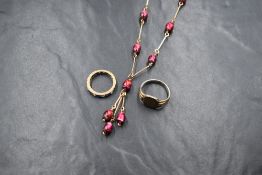 A yellow wire and cerise glass bead necklace with tassel decoration, a silver gilt signet ring, size
