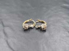 A pair of yellow metal presumed gold diamond set drop earrings, having three graduated rose cut
