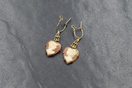 A pair of 9ct gold mounted cameo drop earrings, the heart motif cameos having a maiden in profile in