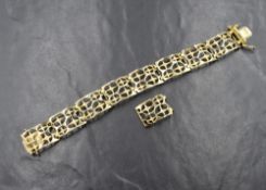 A 9ct gold fancy link bracelet, the eight articulated openwork links having textured star motifs,