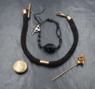 A cased pinchbeck and glass stick pin, a plaited horse hair and yellow metal Albert bearing