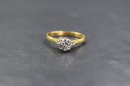 An 18ct gold diamond set solitaire ring, the round brilliant cut diamond measuring approximately 0.