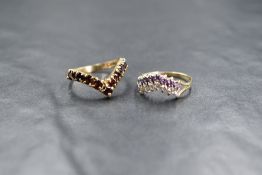 A 9ct gold cubic zirconia and purple paste set double wishbone ring, having split shoulders,