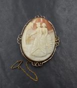 A large conch shell cameo brooch depicting two maidens promenading, in a 9ct rose gold decorative