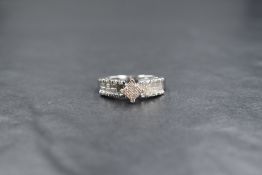 A 14ct white gold diamond set cluster ring, the central square cluster having sixteen pave set