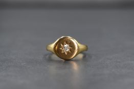 An 18ct gold signet ring having a diamond insert in a star setting, size S & 6.4g