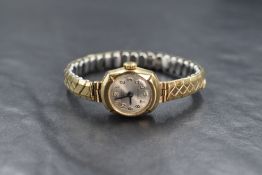 A ladies vintage 9ct gold wrist watch by Excalibur having an Arabic numeral dial to silvered face in