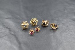 Three pairs of 9ct gold earrings of various designs, two pairs having sapphire stones and one having