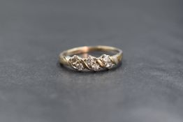 A 9ct gold diamond set band, the six round brilliant cut diamonds measuring approximately 0.04ct