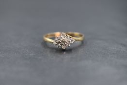 A 9ct gold diamond set cluster ring, the central round brilliant cut diamond in an eight diamond