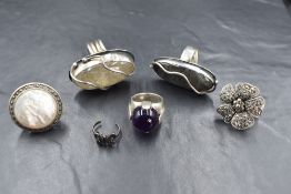 A group of six silver and white metal rings, comprising two artisan labradorite and rutile quartz