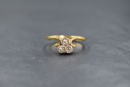 A 22ct gold diamond trio ring having three small old cut diamonds in an illusionary setting with