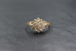 A 9ct gold cubic zirconia set cluster ring, the nineteen round cut cubic zirconia in a step setting,